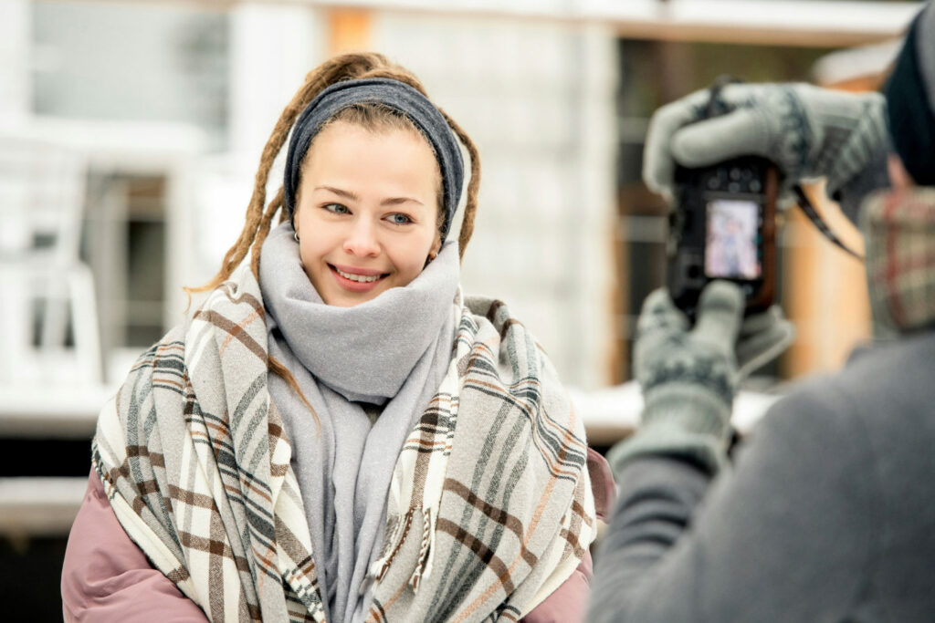 model in warme kledij en fotograaf met handschoenen in koude omgeving