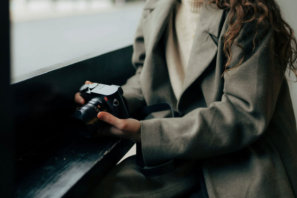 vrouwelijke fotograaf met Leica camera in de hand