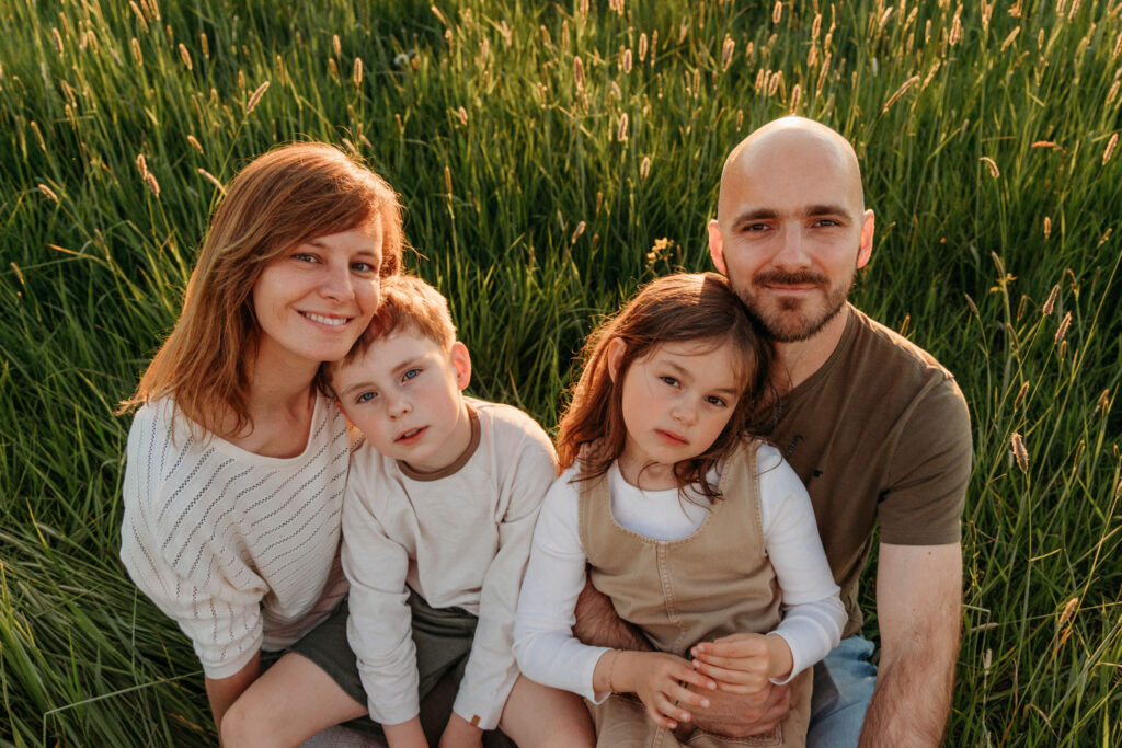 familiefoto van ouders en twee kinderen in het riet